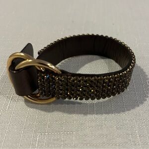 Daniel Swarovski Paris, brown crystal and leather adjustable buckle strap.